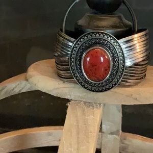Beautiful cuff bracelet in burnished, silver and simulated red coral stone